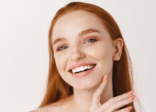 Photo of a woman with red hair and great skin
