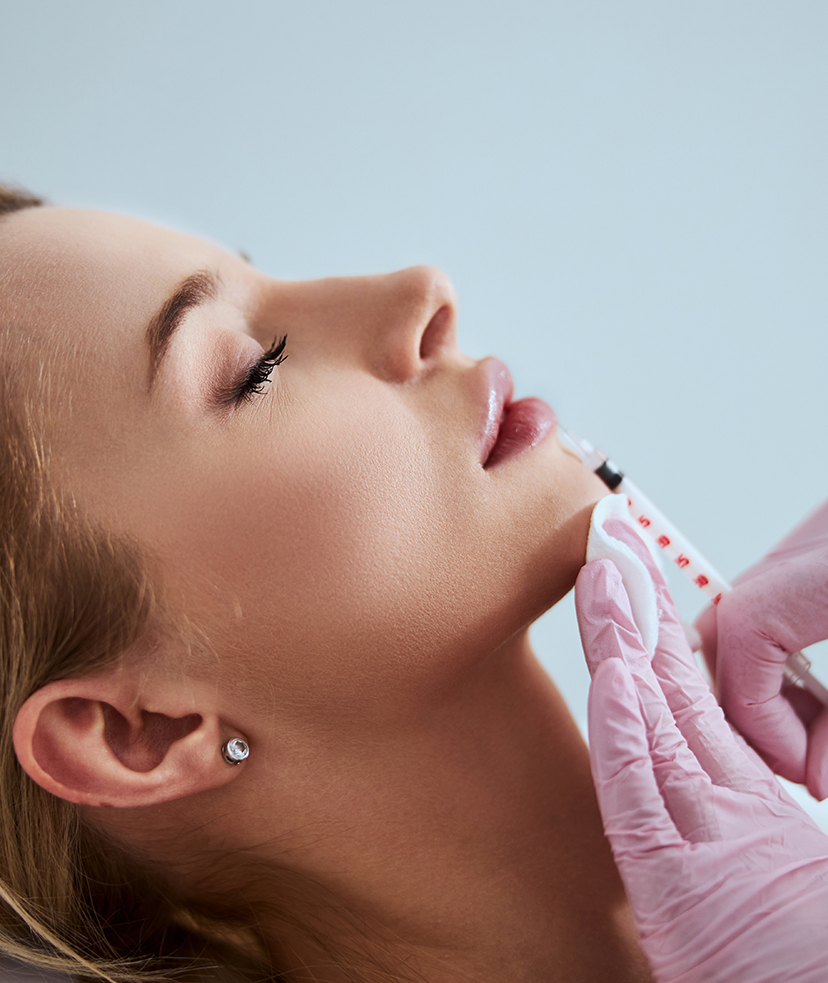Photo of a woman getting filler treatments to her lips